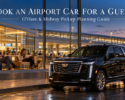Traveler checks a prearranged private airport pickup confirmation while a black 2026 Cadillac Escalade waits outside a Chicago airport arrivals area.